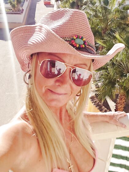 fingering outside on my balcony in pink bikini top and cowgirl hat