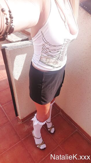 selfshot in short skirt high heels and knee high socks