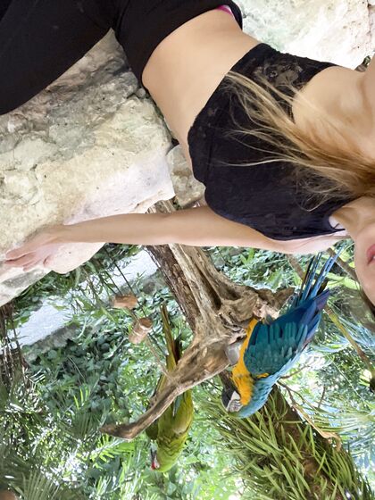 Melena Maria Rya with parrots