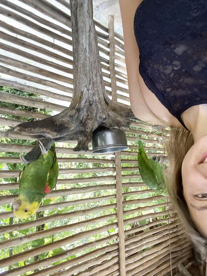 Melena Maria Rya with parrots