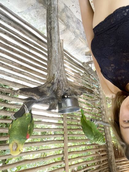 Melena Maria Rya with parrots