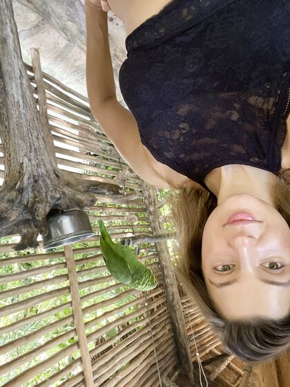 Melena Maria Rya with parrots