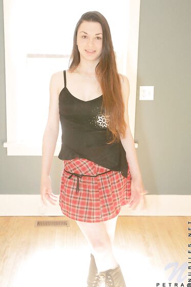 Shedding Her School Girl Uniform Petra Nubiles Exhibits Her Lean And Tight Body With Long Hair