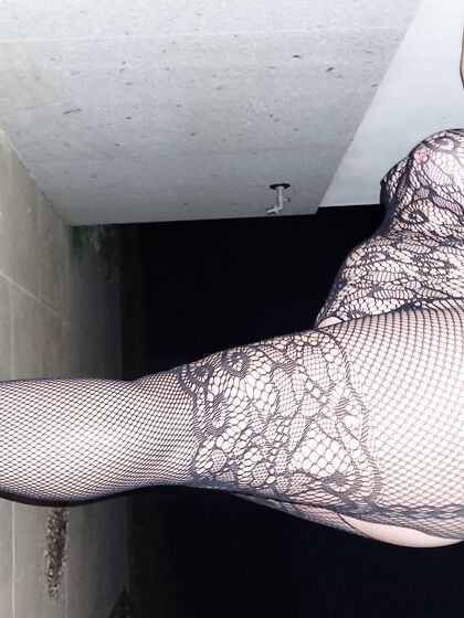 Nikki Holland Possing Oudoors In Bodystockings