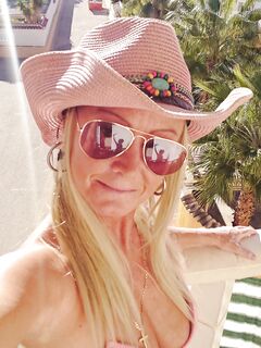 fingering outside on my balcony in pink bikini top and cowgirl hat