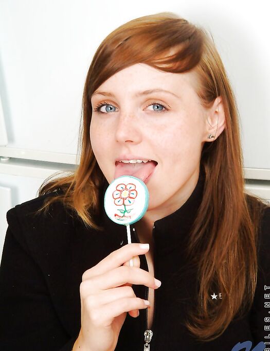 Red Haired Teen Babe Beth Nubiles Slowly Strips While Eating A Lollipop.